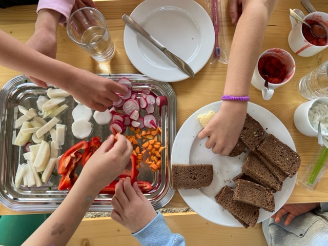 Die Kinder genießen die gemeinsam zubereitete Mahlzeit